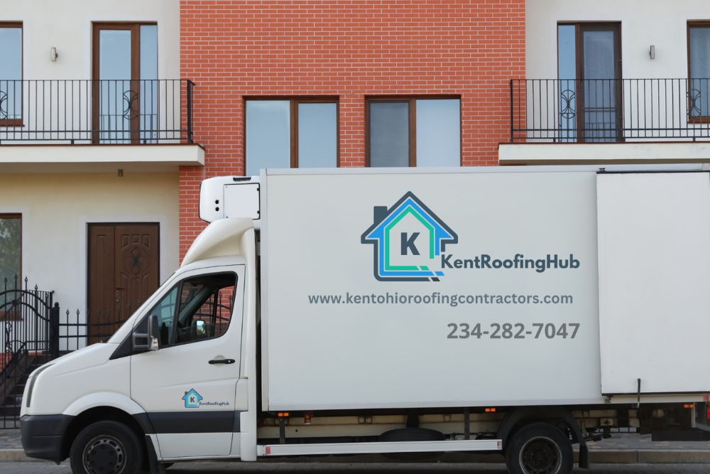 A moving truck stands in front of a house, representing a fresh start in Akron, OH, where we provide expert roofing services.